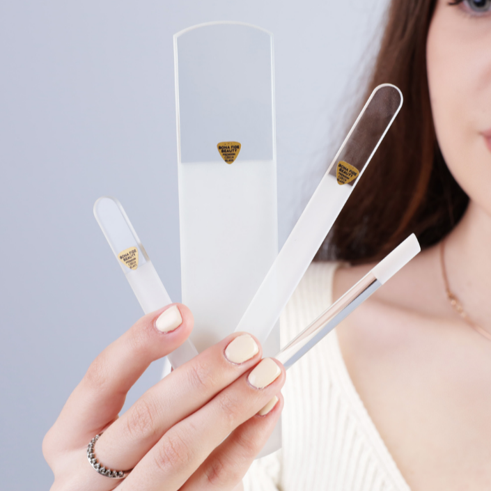 4-Piece Czech Glass File Starter Kit in Clear held by a woman showcasing premium nail care tools.